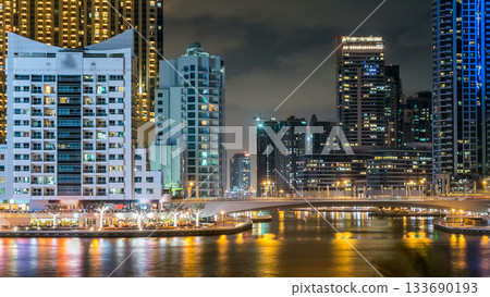 Dubai Marina towers and canal in Dubai night timelapse 133690193