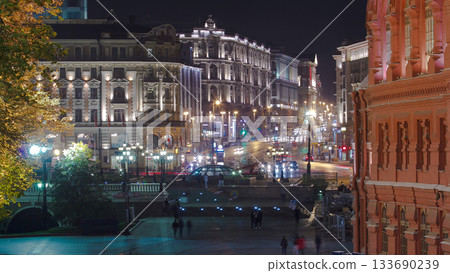 People walking on Manezh Square at night in Moscow. Tverskaya Street is in the background timelapse 133690239
