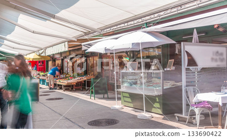 Famous Viennese Naschmarkt food market timelapse with customers stralling between the vegetable and fish stalls in Vienna, Austria Famous Viennese Naschmarkt food market timelapse with customers stralling between the vegetable and fish stalls in Vienna, Austria 133690422