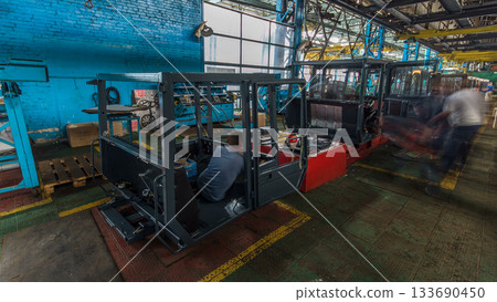 Conveyor assembly stage the body of tractor at big industrial factory timelapse 133690450