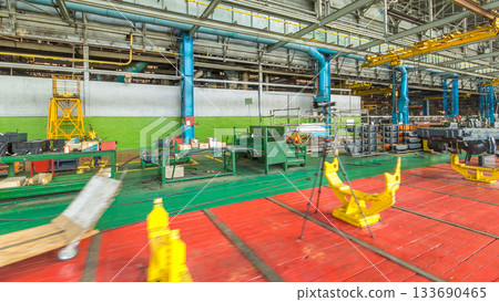 Conveyor assembly stage the body of tractor at big industrial factory timelapse 133690465