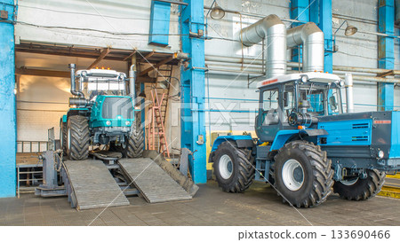 Conveyor assembly final stage of tractor at factory timelapse Conveyor assembly final stage of tractor at factory timelapse 133690466
