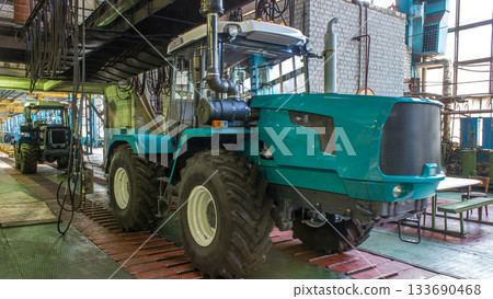 Conveyor assembly stage the body of tractor at big industrial factory timelapse Conveyor assembly stage the body of tractor at big industrial factory timelapse 133690468
