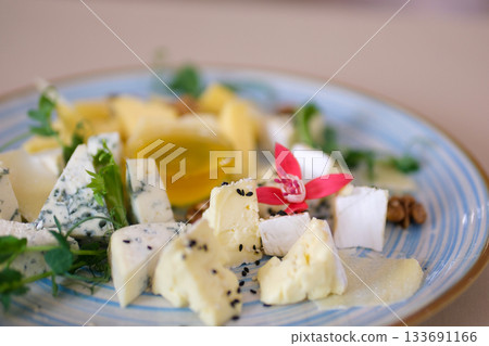 Cheese plate Different sorts of cheese on wooden plate with almonds  133691166