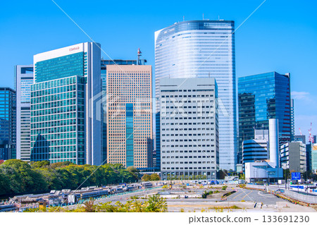 Tokyo cityscape in Japan: View of the Shiodome buildings and the former Tsukiji Market (6) including the temporary access road and removal of the upper structure of the loading pier 133691230