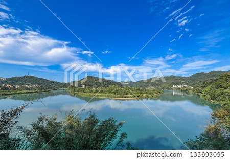 Reflections on Qingtan Weir Lake Surrounded by Mountains in Xindian Taiwan. 133693095