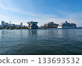 Asuka III and Diamond Princess moored side by side at Yokohama Osanbashi Pier, with the Yokohama Minato Mirai district visible in the background. 133693532