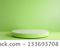 empty white round podium on green background 133693708