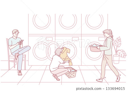 People washing clothes in laundromat 133694015