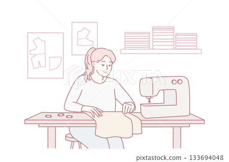 Craftsman carefully stitching fabric at machine amidst essential tailoring tools in artisan studio 133694048