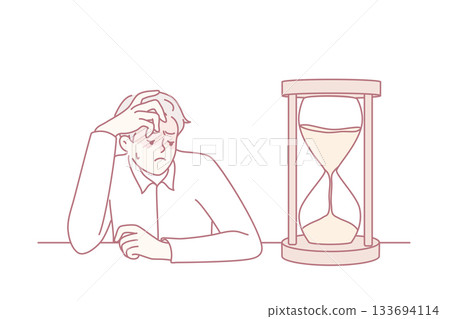 Tired businessman looking at hourglass 133694114