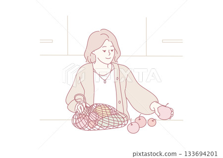 environmentally conscious woman tidying organic apples from reusable shopping bag in modern kitchen environmentally conscious woman tidying organic apples from reusable shopping bag in modern kitchen 133694201