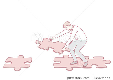 Man connecting jigsaw puzzle making way 133694333