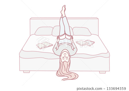 Woman lounging with book and tablet, Young lady in pajamas relaxing with reading devices and book 133694359