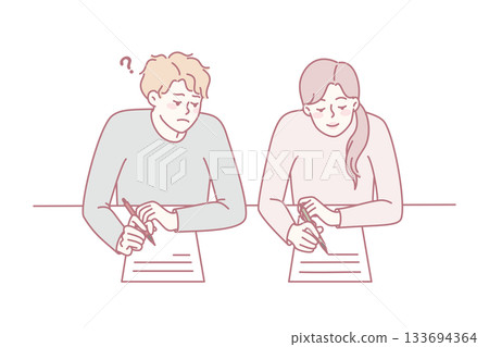 Boy cheating on school exam 133694364