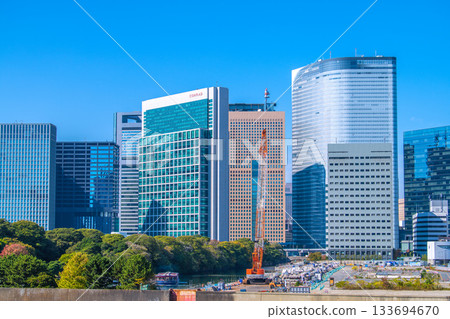 Tokyo cityscape in Japan: View of the Shiodome buildings and the former Tsukiji Market (6) including the temporary access road and removal of the upper structure of the loading pier 133694670