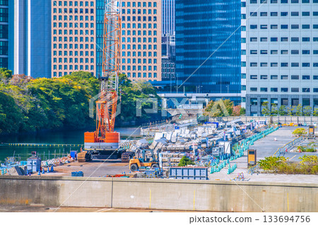 Tokyo cityscape in Japan: View of the Shiodome buildings and the former Tsukiji Market (6) including the temporary access road and removal of the upper structure of the loading pier 133694756