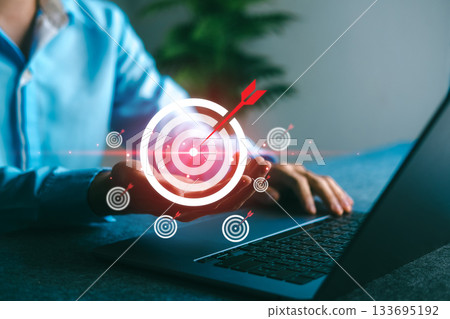 Business goal and success targeting concept with man holding digital target symbol, representing strategy, achievement, and precision planning in a modern business environment. 133695192