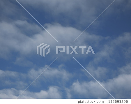 Texture of a refreshingly clear blue sky and flowing white clouds Texture of a refreshingly clear blue sky and flowing white clouds 133695296