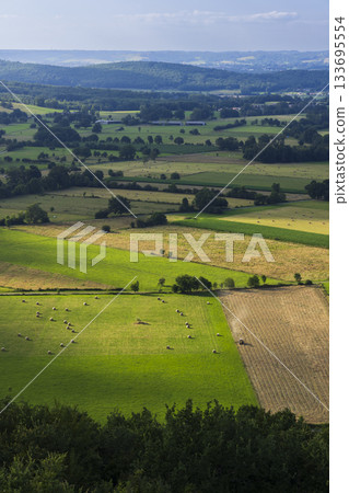 French Pyrenees rural landscape showing farmlands and hay bales French Pyrenees rural landscape showing farmlands and hay bales 133695554