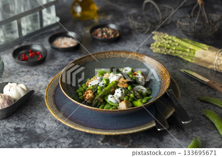 Fresh asparagus and pea salad with chicken and yogurt 133695671