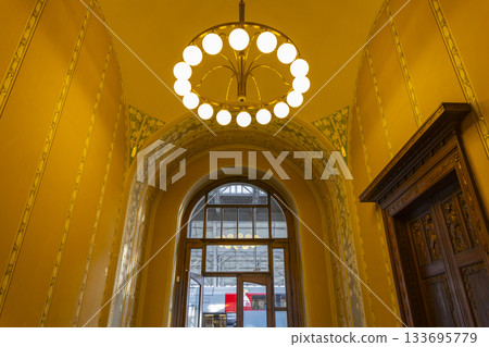 Art Nouveau chandelier illuminating Prague main station interior 133695779