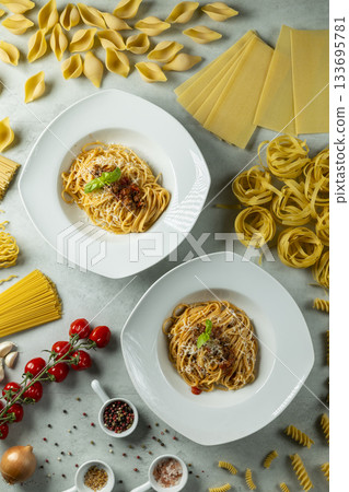 Two bowls of spaghetti bolognese with fresh ingredients Two bowls of spaghetti bolognese with fresh ingredients 133695781