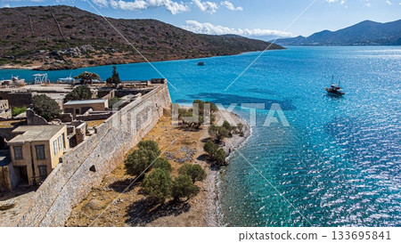 Spinalonga Venetian Fortress. Pristine Water. Side Beach. Crete. Greece Spinalonga Venetian Fortress. Pristine Water. Side Beach. Crete. Greece 133695841