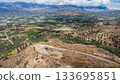 Aerial View of Olive Trees sorrounding Phaistos Palace. Crete. Greece. 133695851
