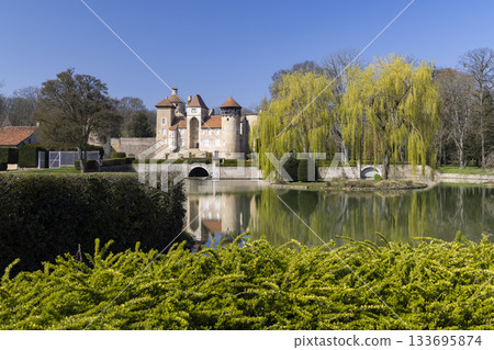 Chateau de Sercy reflecting in moat during spring day Chateau de Sercy reflecting in moat during spring day 133695874