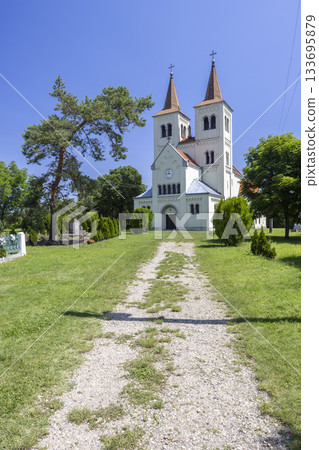 White church in Bina, Slovakia with twin spires White church in Bina, Slovakia with twin spires 133695879