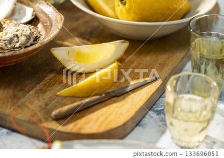Oysters seafood appetizer with lemons and white wine 133696051