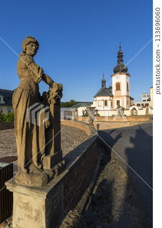 Baroque statue and Church of Saint John the Baptist Manetin Baroque statue and Church of Saint John the Baptist Manetin 133696060