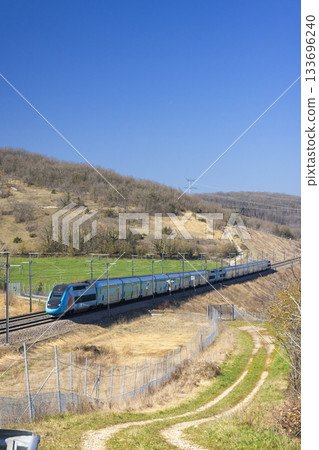High speed passenger train traveling through rural France High speed passenger train traveling through rural France 133696240