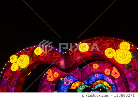Colorful illuminated heart arches creating a festive night display 133696271