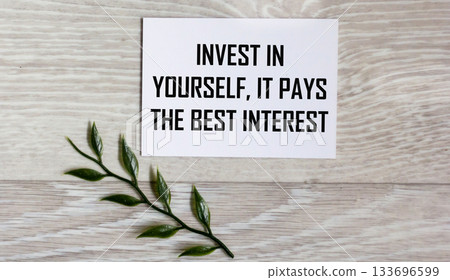 Invest in yourself, it pays the best interest - text written in a notebook. 133696599