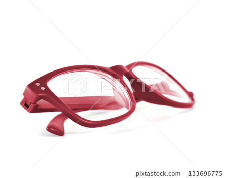Red glasses with folded arms isolated on a white background Red glasses with folded arms isolated on a white background 133696775