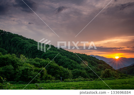 Minamiaizu Town, Fukushima Prefecture - A beautiful sunset over the mountains in early summer and the green scenery 133696884