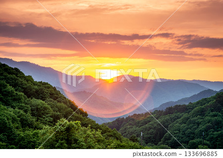 A beautiful early summer sunset over the mountains and green scenery of Minamiaizu Town, Fukushima Prefecture 133696885