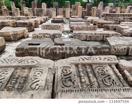 Ancient stone ruins with a pattern, fragments of ancient buildings and structures of the Mauryan empire (Indian ancient history) 133697504