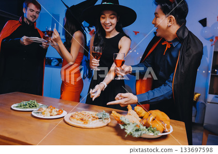 Joyful office Halloween party with coworkers in costumes, celebrating with drinks and laughter, fostering teamwork and festive spirit 133697598