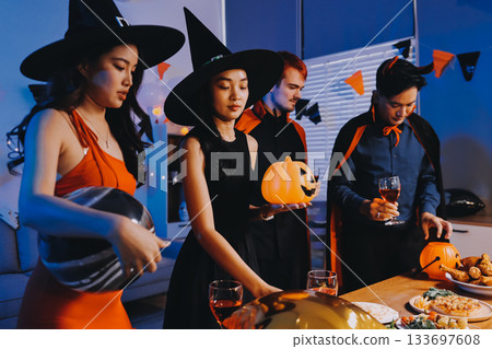 Joyful office Halloween party with coworkers in costumes, celebrating with drinks and laughter, fostering teamwork and festive spirit Joyful office Halloween party with coworkers in costumes, celebrating with drinks and laughter, fostering teamwork and festive spirit 133697608