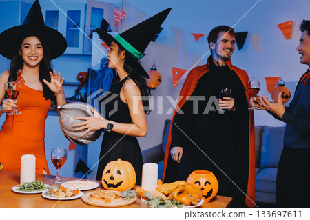 Joyful office Halloween party with coworkers in costumes, celebrating with drinks and laughter, fostering teamwork and festive spirit Joyful office Halloween party with coworkers in costumes, celebrating with drinks and laughter, fostering teamwork and festive spirit 133697611