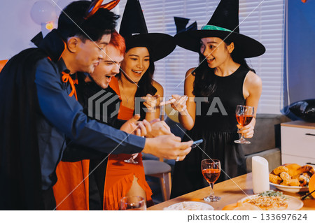 Joyful office Halloween party with coworkers in costumes, celebrating with drinks and laughter, fostering teamwork and festive spirit Joyful office Halloween party with coworkers in costumes, celebrating with drinks and laughter, fostering teamwork and festive spirit 133697624