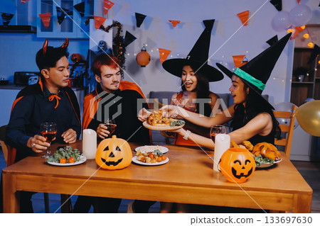 Joyful office Halloween party with coworkers in costumes, celebrating with drinks and laughter, fostering teamwork and festive spirit 133697630
