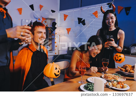 Joyful office Halloween party with coworkers in costumes, celebrating with drinks and laughter, fostering teamwork and festive spirit 133697637