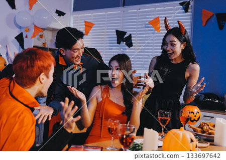 Joyful office Halloween party with coworkers in costumes, celebrating with drinks and laughter, fostering teamwork and festive spirit 133697642