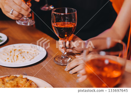 Joyful office Halloween party with coworkers in costumes, celebrating with drinks and laughter, fostering teamwork and festive spirit 133697645