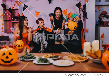 Joyful office Halloween party with coworkers in costumes, celebrating with drinks and laughter, fostering teamwork and festive spirit Joyful office Halloween party with coworkers in costumes, celebrating with drinks and laughter, fostering teamwork and festive spirit 133697653