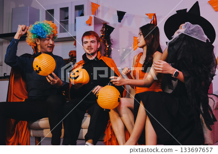Joyful office Halloween party with coworkers in costumes, celebrating with drinks and laughter, fostering teamwork and festive spirit Joyful office Halloween party with coworkers in costumes, celebrating with drinks and laughter, fostering teamwork and festive spirit 133697657